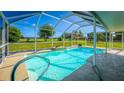 Inviting screened pool with waterfall feature at 174 Juniper Trl, Ocala, FL 34480