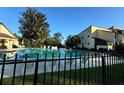 Community pool with lounge chairs and fencing at 3507 E Fort King St # 235, Ocala, FL 34470