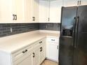 Modern kitchen with white cabinets, new appliances, and a breakfast bar at 8424 Sw 107Th Pl, Ocala, FL 34481