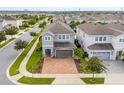 Aerial view of house, driveway, and surrounding neighborhood at 7694 Graben St, Kissimmee, FL 34747