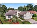 One-story home with attached garage and lush landscaping at 11610 Sw 75Th Cir, Ocala, FL 34476