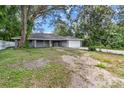 Newly constructed home with gray exterior, attached garage, and covered porch at 1251 Ne 35Th St, Ocala, FL 34479