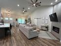 Open living space with high ceilings, hardwood floors, and a modern fireplace at 1965 County Road 243C, Wildwood, FL 34785