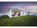 Covered patio with seating area overlooking a spacious grassy backyard at 8314 Sw 59Th Ter, Ocala, FL 34476