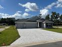 Newly built home with three-car garage and stone accents at 7160 Sw 179Th Court Rd, Dunnellon, FL 34432