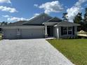 Newly built home with three-car garage and stone accents at 7160 Sw 179Th Court Rd, Dunnellon, FL 34432