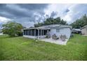 Spacious backyard with patio, screened enclosure, and solar panels at 9698 Sw 96Th St, Ocala, FL 34481
