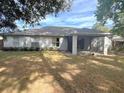 Large backyard with a screened patio and lush grass at 2712 Ne 26Th St, Ocala, FL 34470