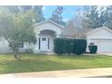 Single-Gathering home with a two-car garage and manicured lawn at 2712 Ne 26Th St, Ocala, FL 34470