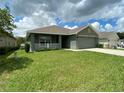 One-story house with a green exterior and a two-car garage at 4426 Nw 2Nd Ct, Ocala, FL 34475