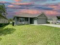 One-story house with a green exterior and a two-car garage at 4426 Nw 2Nd Ct, Ocala, FL 34475