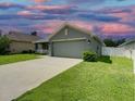 One-story house with a green exterior and a two-car garage at 4426 Nw 2Nd Ct, Ocala, FL 34475