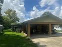 Attached carport with space for golf cart and storage at 8098 Se 21St Ave, Ocala, FL 34480