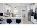 Modern kitchen with island, white cabinets and stainless steel appliances at 7531 Sw 77Th Ave, Ocala, FL 34481