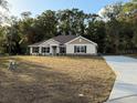 New construction home with a brown roof, stone and stucco siding, and a concrete driveway at 40 113Th Cir, Ocala, FL 34482