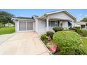 Exterior of a house with landscaping and a screened-in garage at 10978 Sw 83Rd Ave, Ocala, FL 34481