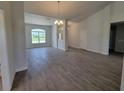 Spacious living room with gray tile floors and large window at 8293 Sw 58Th Ave, Ocala, FL 34476