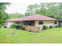 Ranch-style home with red roof and stone accents at 21389 Sw 102Nd Street Rd, Dunnellon, FL 34431