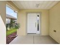 Front entrance with white door and covered porch at 8601 Se 133Rd St, Summerfield, FL 34491