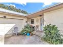 Inviting home exterior featuring a covered entryway, attached garage, and well-maintained landscaping at 6340 Se 127Th Pl, Belleview, FL 34420