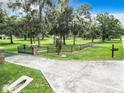 Landscaped entrance to a property with a long driveway and wooden fence at 3421 Nw 2Nd Ave, Ocala, FL 34475