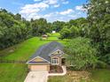 Aerial view of a house with a large backyard, a shed, and a fenced area at 9680 Ne 25Th Ct, Anthony, FL 32617
