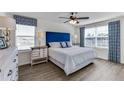 Bright bedroom with a blue headboard and window at 6595 Sw 81St Loop, Ocala, FL 34476