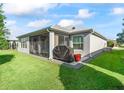 Private backyard with screened patio and grill at 3812 Nottingham Loop, The Villages, FL 32163