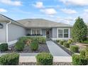 Inviting front entry with landscaped walkway at 3812 Nottingham Loop, The Villages, FL 32163