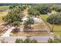 Aerial view of a single-story home with fenced yard and expansive green space at 12342 Sw 112Th Street Rd, Dunnellon, FL 34432