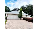 Brick driveway and well maintained landscaping at 17808 Se 115Th Ct, Summerfield, FL 34491