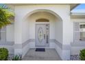 Elegant front door entryway with arched alcove and decorative glass at 4978 Nw 33Rd Ln, Ocala, FL 34482