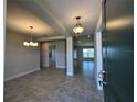 Bright and spacious entryway with tile floors and a view into the living room at 13275 Sw 60Th Court Rd, Ocala, FL 34473