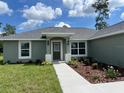 Newly built home with two-car garage and landscaping at 15443 Sw 23Rd Ct, Ocala, FL 34473