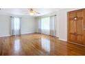 Bright living room with hardwood floors and large windows at 11348 Se 55Th Ave, Belleview, FL 34420