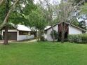 Ranch-style home with attached garage and mature landscaping at 1536 Se 43 Ter, Ocala, FL 34471