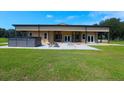 Ranch style home with covered patio, hot tub, and fire pit at 2051 Se 155Th St, Summerfield, FL 34491