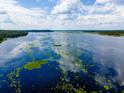 Aerial view of a vast lake reflecting the sky, with some vegetation visible at 24750 Ne 177Th Ter, Fort Mc Coy, FL 32134