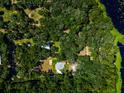 Aerial view of a house nestled in a wooded area near a lake at 24750 Ne 177Th Ter, Fort Mc Coy, FL 32134