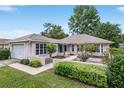 Single-story house featuring a two-car garage and well-manicured lawn at 11536 Sw 70Th Ct, Ocala, FL 34476