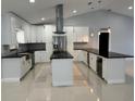 Modern kitchen with large island and stainless steel appliances at 8028 Se 62Nd Ln, Ocala, FL 34472
