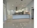 Modern kitchen with large island and stainless steel appliances at 8028 Se 62Nd Ln, Ocala, FL 34472