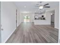 Open concept living area with gray vinyl flooring and a ceiling fan at 65 Fisher Way, Ocklawaha, FL 32179