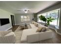 Living room featuring a comfy sectional sofa and large windows at 9526 Sw 72Nd Ct, Ocala, FL 34476