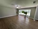 Bright living room with hardwood floors and large windows at 9526 Sw 72Nd Ct, Ocala, FL 34476
