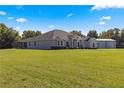 Single-story house with attached garage, set on a large lot at 5615 Nw 202Nd Pl, Mc Intosh, FL 32664