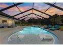 Inviting pool and screened enclosure, perfect for relaxation and entertainment at 5615 Nw 202Nd Pl, Mc Intosh, FL 32664