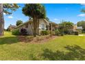 Landscaped yard with lush green grass and mature trees at 2215 Se 24Th Ave, Ocala, FL 34471