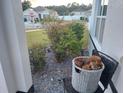 Inviting front porch with a wood storage basket and landscaping at 4551 Ne 27Th St, Ocala, FL 34470