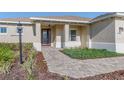 Inviting front entrance with a paved walkway and landscaping at 9400 Sw 106Th Ave, Ocala, FL 34481